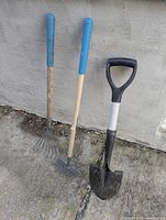 Front view of two Yardworks kids rakes and one kids spade shovel