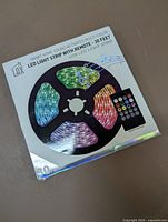 Front of retail package showing LED strip reel and remote