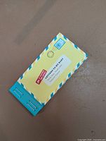 Front view of the unused Letters to My Baby booklet showing cover design and stapled spine