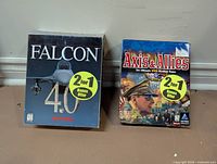 Front view of both game boxes with 2-for-1 stickers