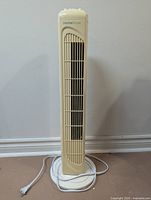 Full view of cream HomeStyles tower fan with power cord