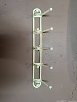 Plastic five-peg wall hook rack front view