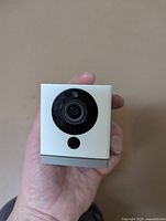 Front view of Wyze cube security camera held in hand