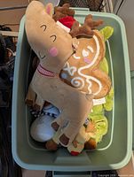 Top view of storage bin showing reindeer, green alligator, white character plush and other small plush toys