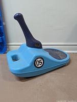 Left side view of blue Zipfy model 05 sled showing handle and seat pad