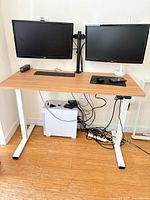 Desk at sitting height with monitors and accessories showing full frame