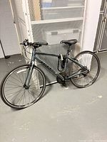 Full side view of Giant bicycle leaning against locker