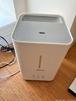 Front view showing Mooka logo, water level window, control icons and power cord