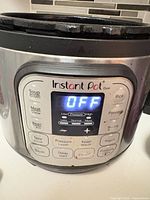 Front view of Instant Pot Duo showing control panel and stainless exterior