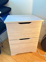 Front view of light wood nightstand with two drawers