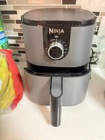 Front view of Ninja air fryer showing dial control and handle