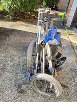 BagBoy golf push cart folded for storage showing wheels and frame