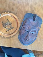 Front view of wooden mask and BC Centenary copper plate