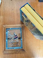 Stained glass panel and two hardcover books with slipcase on table