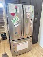 Front view showing full refrigerator with doors and drawer closed