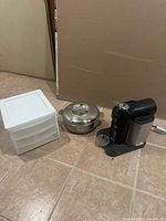 Overview of all three items: plastic drawer unit, stainless hot pot, Nespresso machine