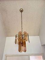 Full view of hanging amber glass chandelier