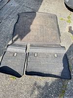 Full view of cargo liner and rear mat laid out on pavement