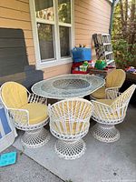 Overall view of table, four chairs, and cushions