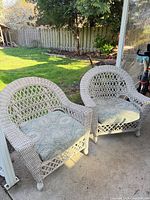 Front view of both wicker armchairs with cushions