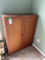 Full view of cabinet showing two doors, knobs, block feet