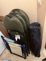 Stack of 4 grey padded folding chairs, folded beach chairs, camping chair bag