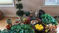 Overall lot showing artificial plants, fruit, planters and décor pieces