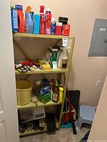 Overall view of shelving with cleaning products, faucet box, bucket, cords and accessories