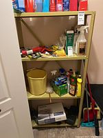 Front view of beige metal shelving unit with four shelves