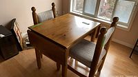 Wooden table with both chairs