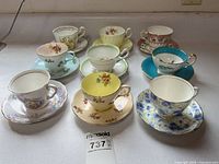 Group shot of all nine teacup and saucer sets
