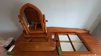 All three pine items—dresser mirror, wall shelf, window pane mirror—grouped on surface