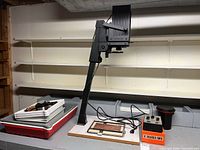 Complete lot showing enlarger on baseboard, timer, developing trays, film tank