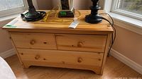 Full view of pine chest showing drawers, knobs and top surface