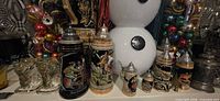 Group view showing steins, glass ornament jars, snowman, bookends