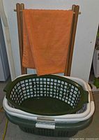 Nested white and green plastic laundry baskets showing overall design and color