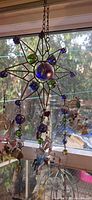 Star-shaped metal frame with colored glass, multiple hanging fairy ornaments visible