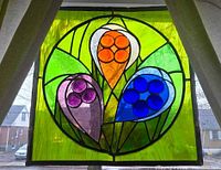 full view of stained glass panel hanging in window
