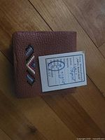 Front of tan leather wallet with bead chevron and 1966 card