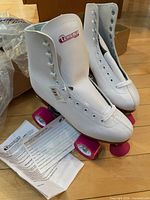 Pair of white Chicago Skates quad skates with tags and paperwork