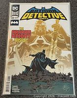 Front cover showing Batman and Arkham Knight imagery, issue details, bag and board visible