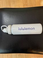 Side view of white Lululemon bottle with lid attached