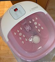 Top view of MaxKare foot spa showing LED display, pink basin, massage rollers and bubble outlets