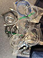 Assorted cables spread on surface showing connectors and jackets