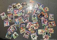 Spread of assorted football trading cards with various border colors and player images