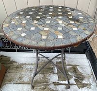 top view showing stone mosaic pattern and measuring tape across diameter