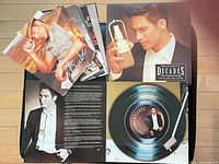 Overview of CD gatefold open with photo cards arrayed