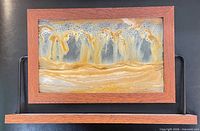 Front view of sand art showing frame, stand and sand pattern