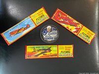 Three sealed glider packs and sealed Mats Sundin puck on black background