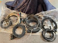 Seven coiled component video cables with black braided and beige PVC jackets